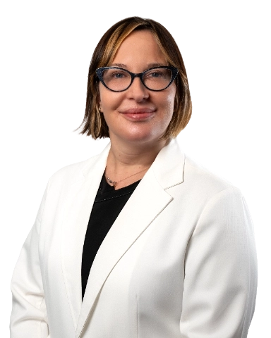 Professional headshot of Dr. Bonnie McKinley wearing a white lab coat, smiling at the camera against a black background. This is a standard medical professional portrait used for clinic or practice identification.